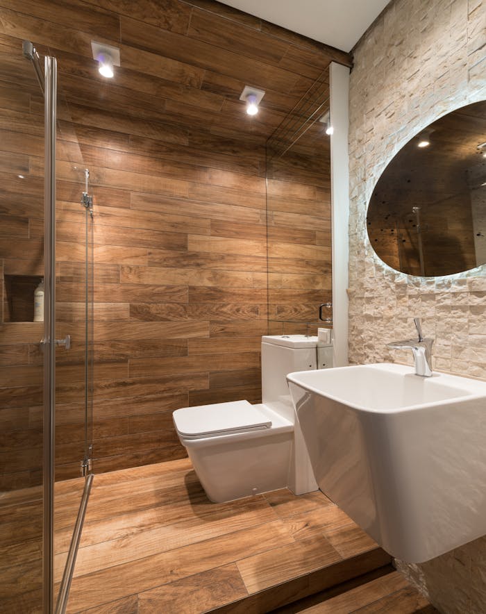 Modern bathroom with wooden walls and sleek sanitary fixtures, designed for relaxation.